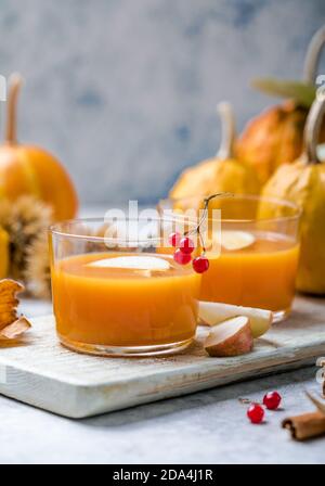hot pumpkin punch or sangria in a glass with apple. Halloween and Thanksgiving beverage. Traditional autumn, winter drinks and cocktails Stock Photo