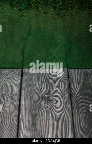 Brushed pine boards painted black and white. The iridescent surface is green. Stock Photo