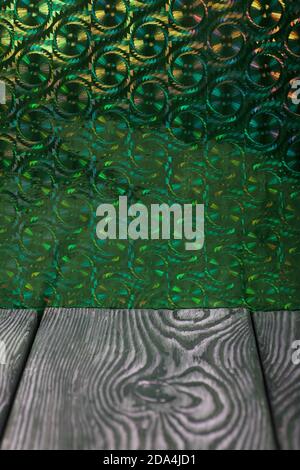 Brushed pine boards painted black and white. The iridescent surface is green. Stock Photo