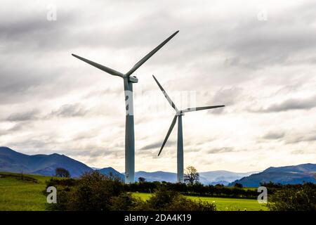 Wind tubines overlooking the English Lake District at Bothel, Cumbria UK Stock Photo