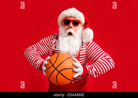 Portrait of his he nice handsome amazed worried nervous fat overweight Santa grandfather playing basketball practicing throwing ball isolated over Stock Photo