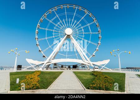 Baku, Azerbaijan – August 2, 2020. Baku Eye Ferris wheel on the seaside boulevard in Baku. View without people in summer. Stock Photo