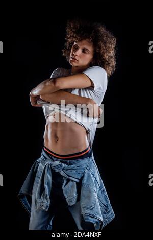 Skinny rock guy wearing  blue jeans pants isolated on black backgorund Stock Photo