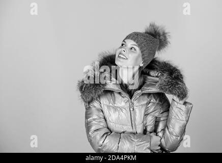 Fashion coat and hat. Fashion trend. Faux fur. Warming up. Casual winter jacket slightly more stylish and have more comfort features such as larger hood fur trim on hood. Fashion girl winter clothes. Stock Photo