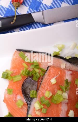 Food concept: red salmon fish and cabbage with red chilli pepper with greens. Healthy food cooking. Stock Photo