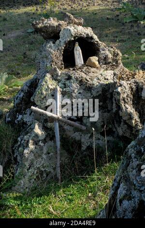 Our Lady of Lourdes in a natural volcanic niche in Etna Park a landmark of nature in Sicily and outdoor tourism Stock Photo