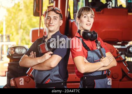 Two machinists for farm machinery in their garage Stock Photo