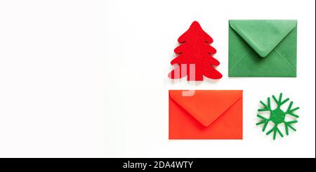 Set of christmas envelopes and felt decoration on white. Banner design, top view, flat lay. Stock Photo