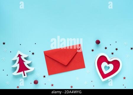 Christmas letter with red and white decorations on pastel blue surface, top view, copy space. Christmas composition. Merry Christmas and Happy Stock Photo