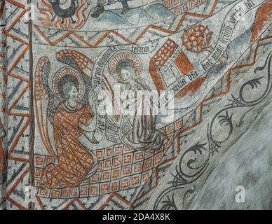 Announcement by the Archangel Gabriel to the Blessed Virgin Mary that she would conceive and become the mother of Jesus. Ancient fresco in Tuse church Stock Photo