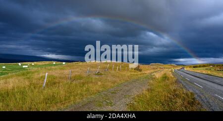Rainbow over field, Fljotsdalsherao, Eastern Region, Iceland Stock Photo
