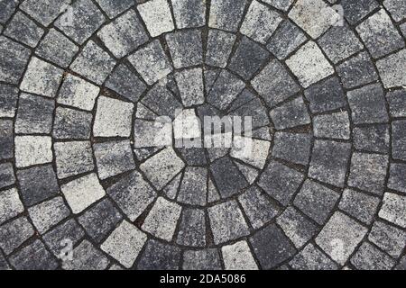Background paving gray stones lined concentric circle. Visual pattern of the floor tiles background. Stock Photo