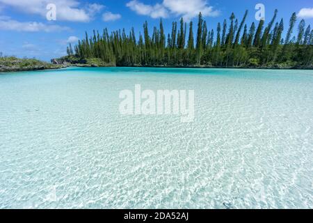 beautiful seascape of natural swimming pool of Oro Bay, Isle of Pines, New Caledonia. aquamarine translucent water. Stock Photo