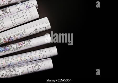 Architectural project, drawings on a dark background. Rolls of project drawings Stock Photo