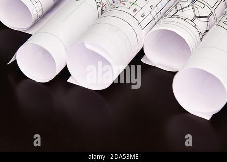 Architectural project, drawings on a dark background. Rolls of project drawings Stock Photo