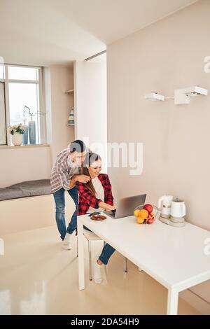Smiling pleased female freelancer working from home Stock Photo