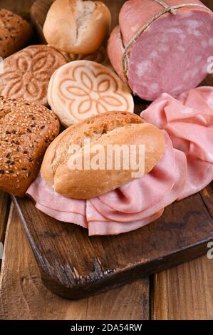 Big Mortadella and Tigelle. Assorted breads of different types, for traditional Italian sandwiches in the region of Emilia Romagna. Above. Copy space Stock Photo
