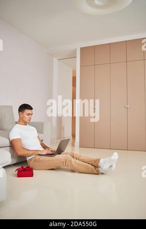 Concentrated attractive man typing on his laptop Stock Photo