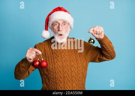 Portrait of his he nice attractive stunned amazed funky bearded grey-haired Santa father holding in hands tree festal balls tinsel pout lips isolated Stock Photo