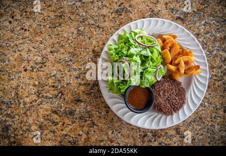 Hamburger patty with green salad and steak fries Stock Photo