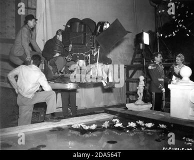 JOHN CROMWELL (in hat) and Film Crew on set candid filming RONALD COLMAN and MADELEINE CARROLL in THE PRISONER OF ZENDA 1937 director JOHN CROMWELL novel Anthony Hope screenplay John L. Balderston music Alfred Newman costumes Ernest Dryden art direction Lyle R. Wheeler producer David O. Selznick  Selznick International Pictures / United Artists Stock Photo