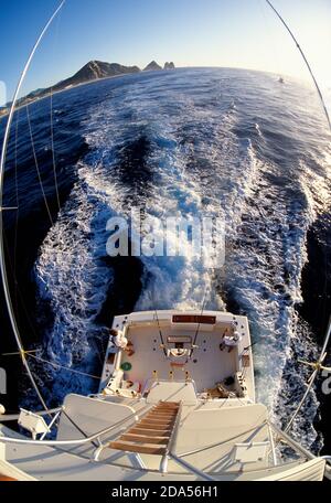 OVERHEAD VIEW OF SPORT-FISHING YACHT SPEEDING AWAY FROM CABO SAN LUCAS, MEXICO Stock Photo