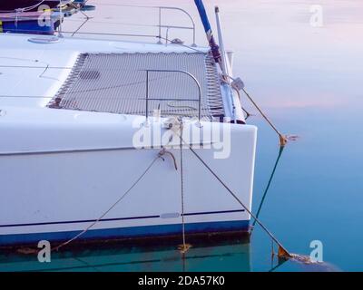 View of the rear of a white yacht moored in the sea Stock Photo