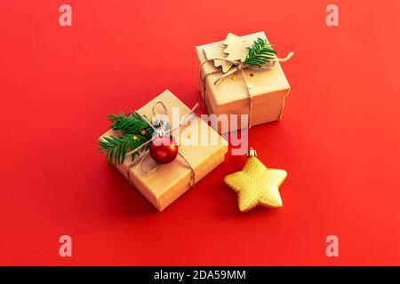 Two gifts in boxes and Christmas toy star on red background, top view. New Year concept Stock Photo
