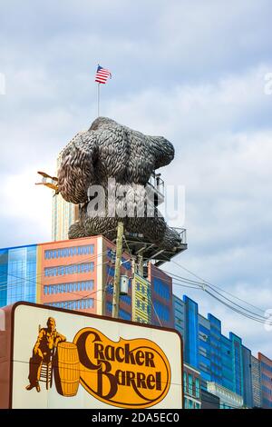 Surreal, rear view of replica of King Kong climbing a building in front of signboard advertising the Cracker Barrel restaurant in Pigeon Forge, TN Stock Photo