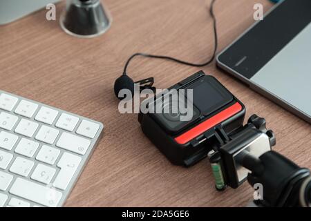 technological gadgets on the work desk, there is a camera, microphone, sd card, keyboard, technology and modern elements Stock Photo