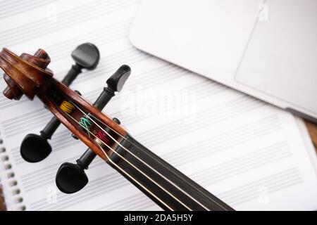 Violin, staff paper, and laptop set up for music composition class Stock Photo