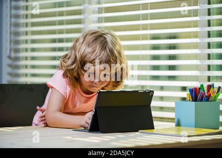 School kid boy making homework math during quarantine time from corona pandemic disease. Education and distance learning for kids. Homeschooling Stock Photo