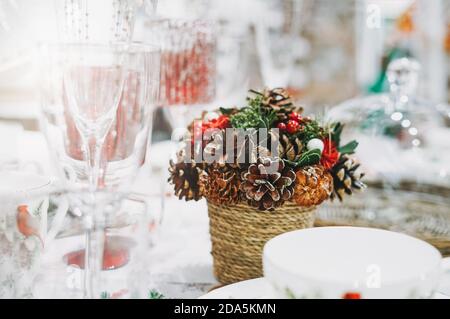 Beautiful Christmas serving with pot with a composition of cones in the home goods store Stock Photo