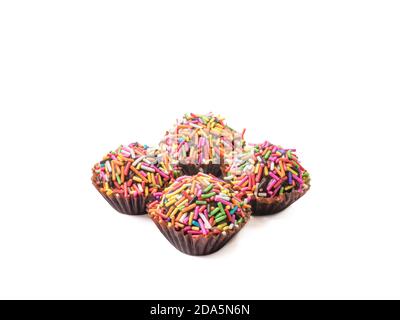 The close up of colorful chocolate balls sweet dessert food on white background. Stock Photo