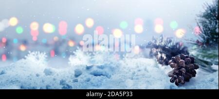 Pine cone on the snow with blurred light background Stock Photo