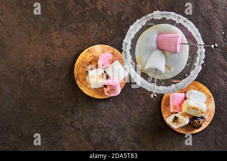 Irish cream liqueur in a martini glass with marshmallows top view. Copy space for text. Stock Photo