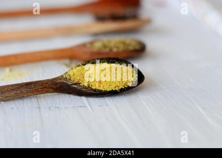 Herbs and spices selection in wooden spoons on a wooden background. Cooking, gardening or vegetarian concept. Stock Photo