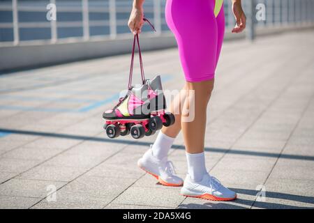 With skates. Close up picture of a girl with roller-skates Stock Photo