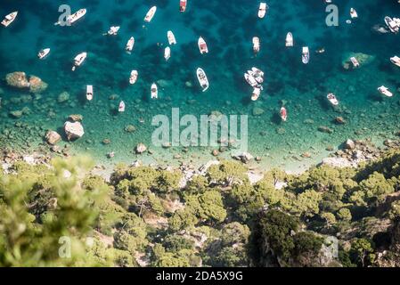 View from the top of many small boats in the sea, on a beautiful sunny summer day. Capri island. Stock Photo