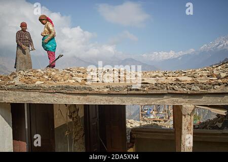 Rasuwa, Nepal, January 2016. People working on their homes destroyed by the April 2015 earthquake. Stock Photo