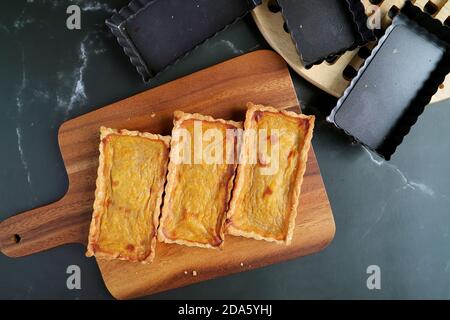 Top View of Just Baked Pumpkin Tartlets on the Wooden Breadboard for the Concept of HOME COOKING Stock Photo