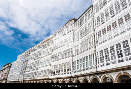 Low angle of white facades with glazed balconies on Avenida de Marina, A Coruña, Galicia Stock Photo