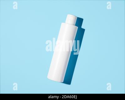 Empty white plastic bottle mockup in hard light. Top view or flat lay. Blank opaque bottle without packaging on blue background. Mock up for package design Stock Photo
