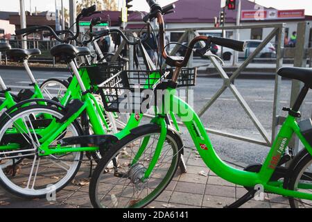 Public bicycles, sharing bikes available for rent on city streets Stock Photo