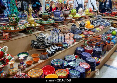 Ceramic Uzbek souvenir painted tea sets and handmade plates at the bazaar. Traditional national art. April 29, 2019 Stock Photo