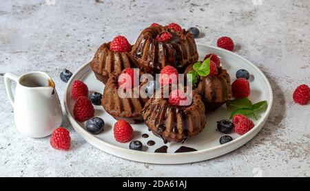 Mini chocolate cakes with chocolate and fresh berries Stock Photo