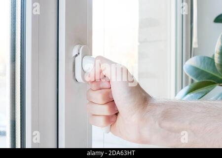 The hand opens a plastic window, the mechanism breaks. Stock Photo
