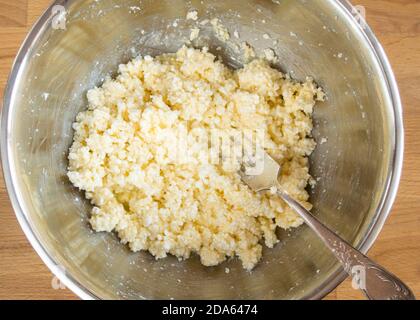 A raw mixture of eggs, cottage cheese and butter for cookies. Top view, no people. Stock Photo