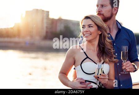Summer holidays and dating concept. Happy romantic couple in love hugging with champagne Stock Photo