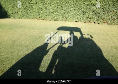 trolley golf car shadow in the fairway Stock Photo